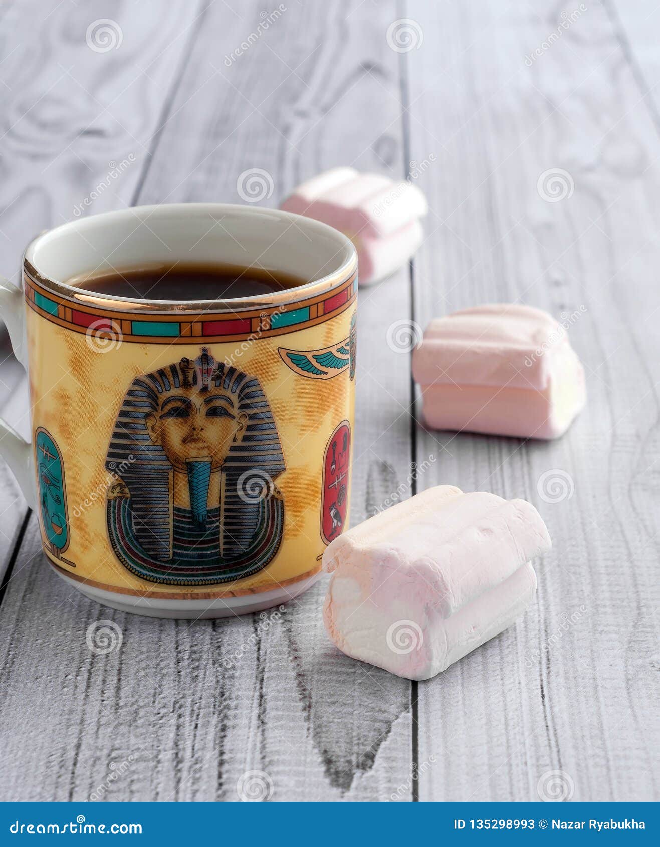 A Cup of Coffee with Egyptian Patterns and Sweet Marshmallows on a Light Wooden Background Stock