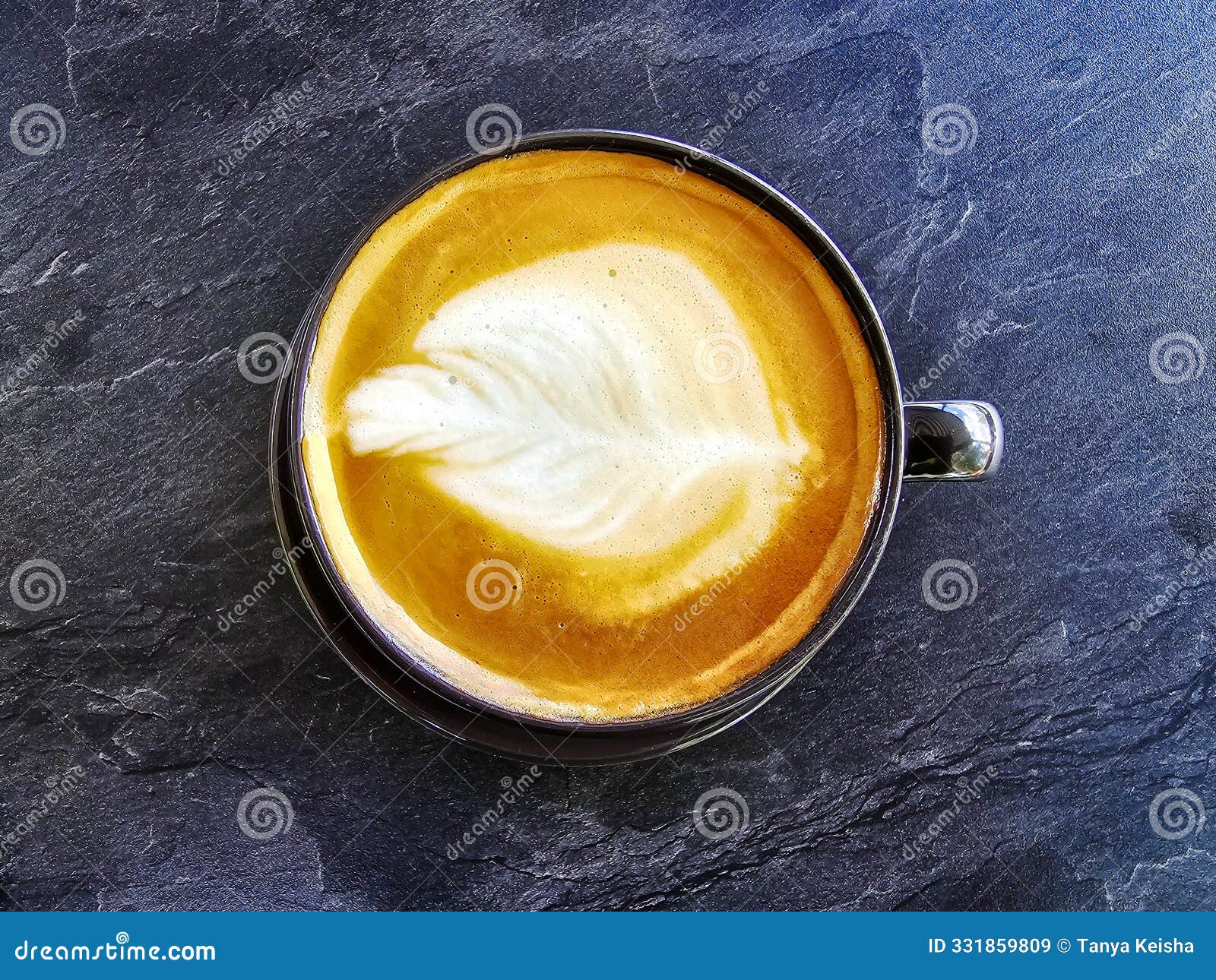 a cup of coffee latte top view with microfoam milk leaf  foam