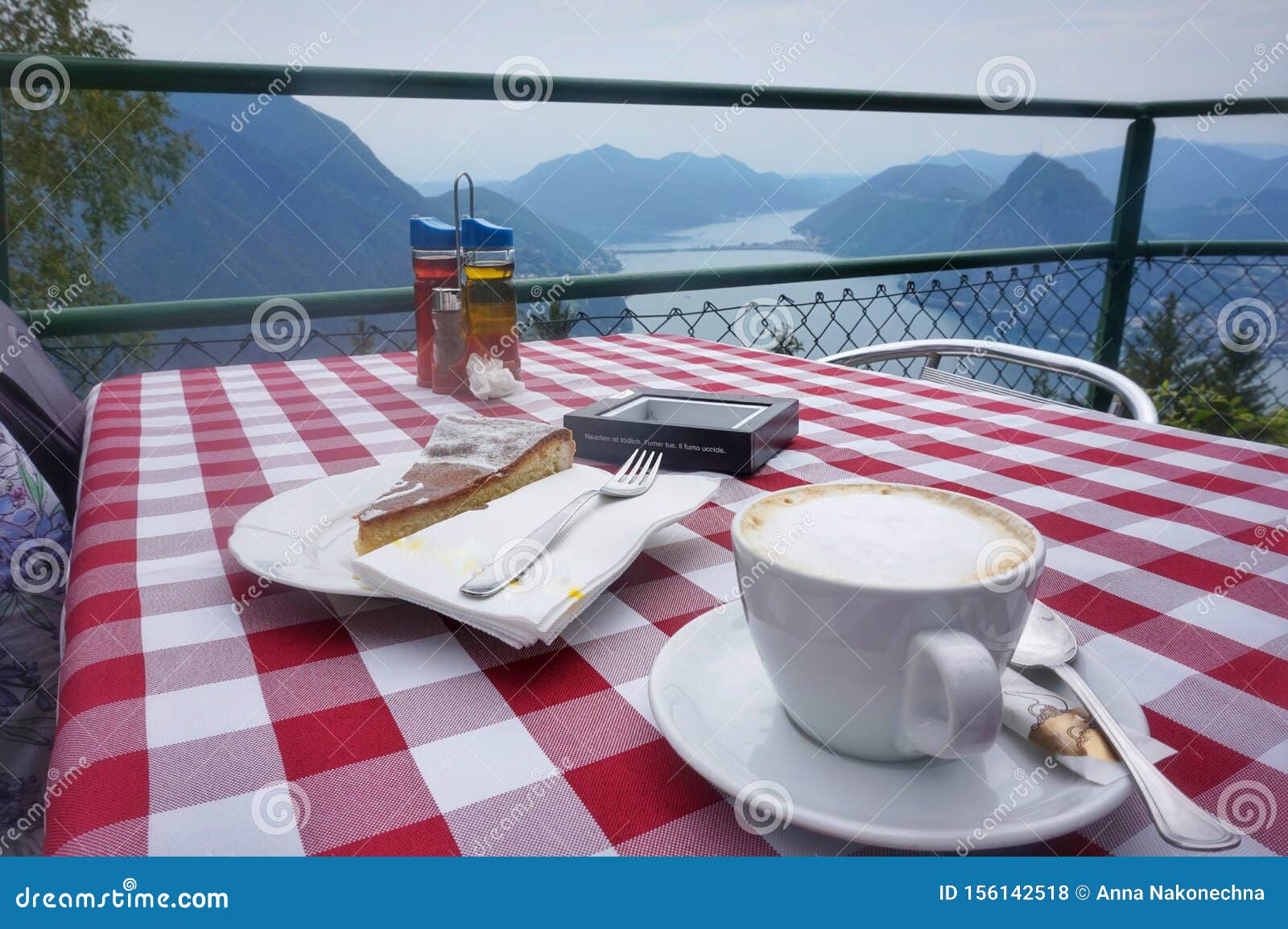 cup of coffee and lemon pie on the table. cafe on mount monte bre.