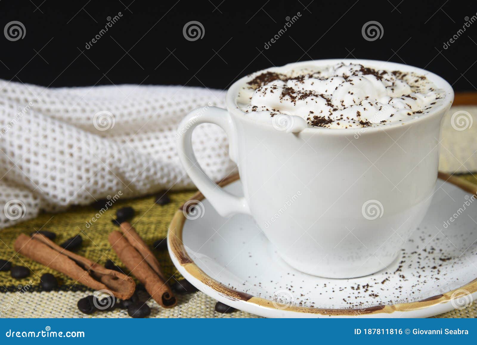 Cup of Coffee with Milk and Whipped Cream on the Table with Roasted