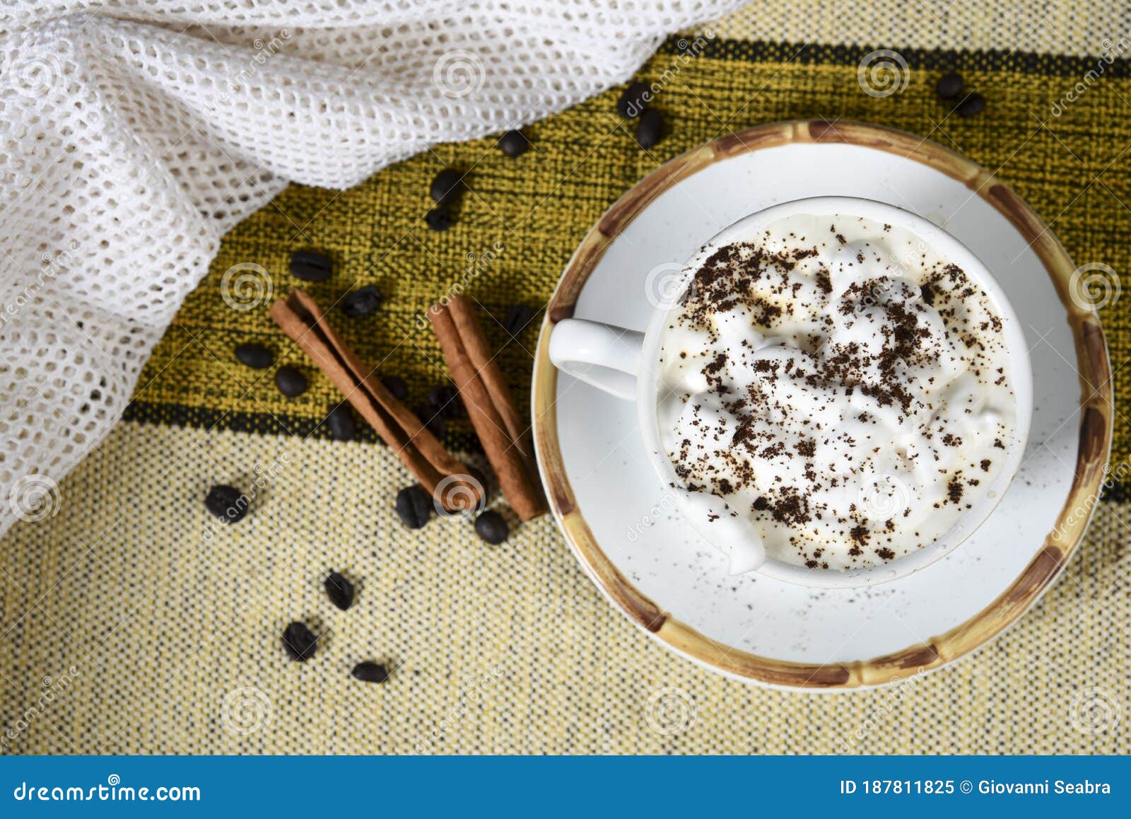 Cup of Coffee with Milk and Whipped Cream on the Table with Roasted
