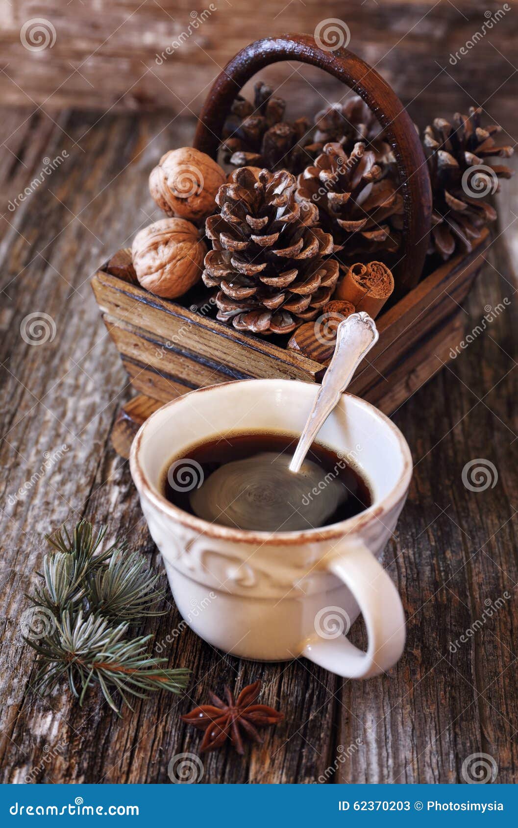 Cup of Coffee, Pine Cones in Basket, Walnuts and Cinnamon Sticks Stock