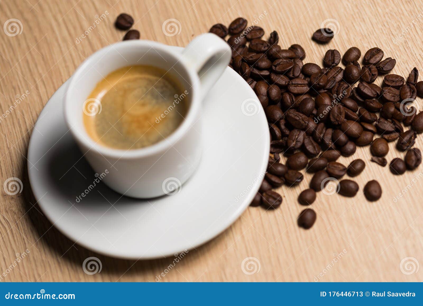 cup of coffee on a wooden table with coffee beans