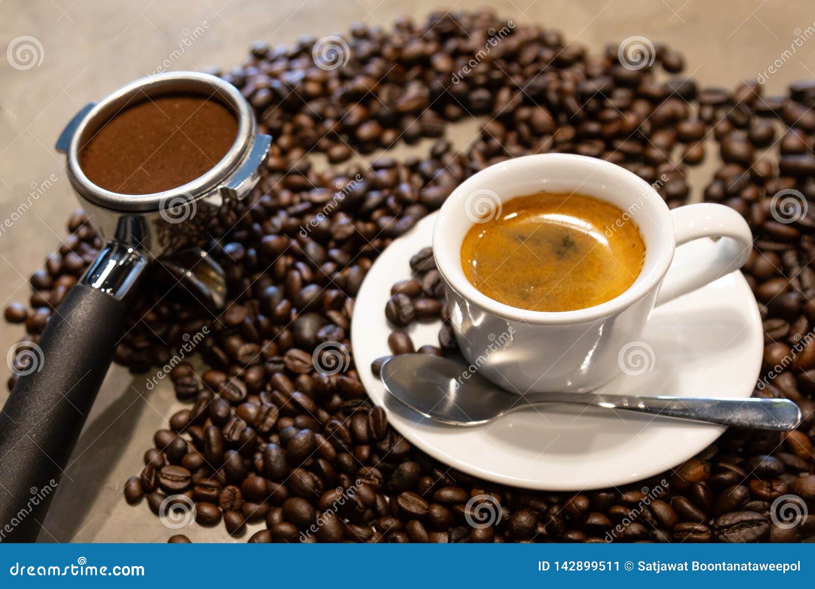 cup of espresso coffee and portafilter on coffee beans background ,fresh espresso with crema perfect shot in the morning at cafe