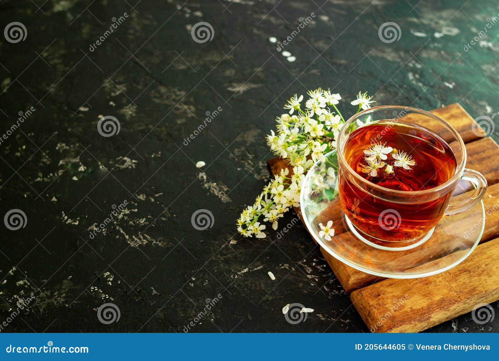 A Cup of Flower Tea with Spring Cherry Blossom on a Black Background