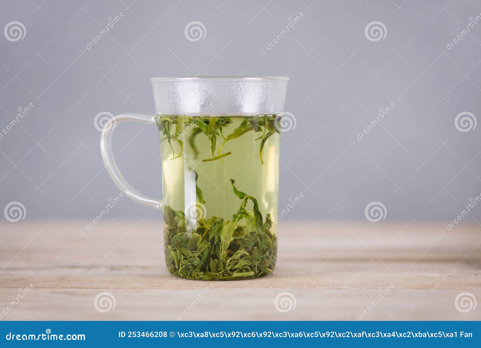 A cup of green tea stock photo. Image of small, flowers 253466208