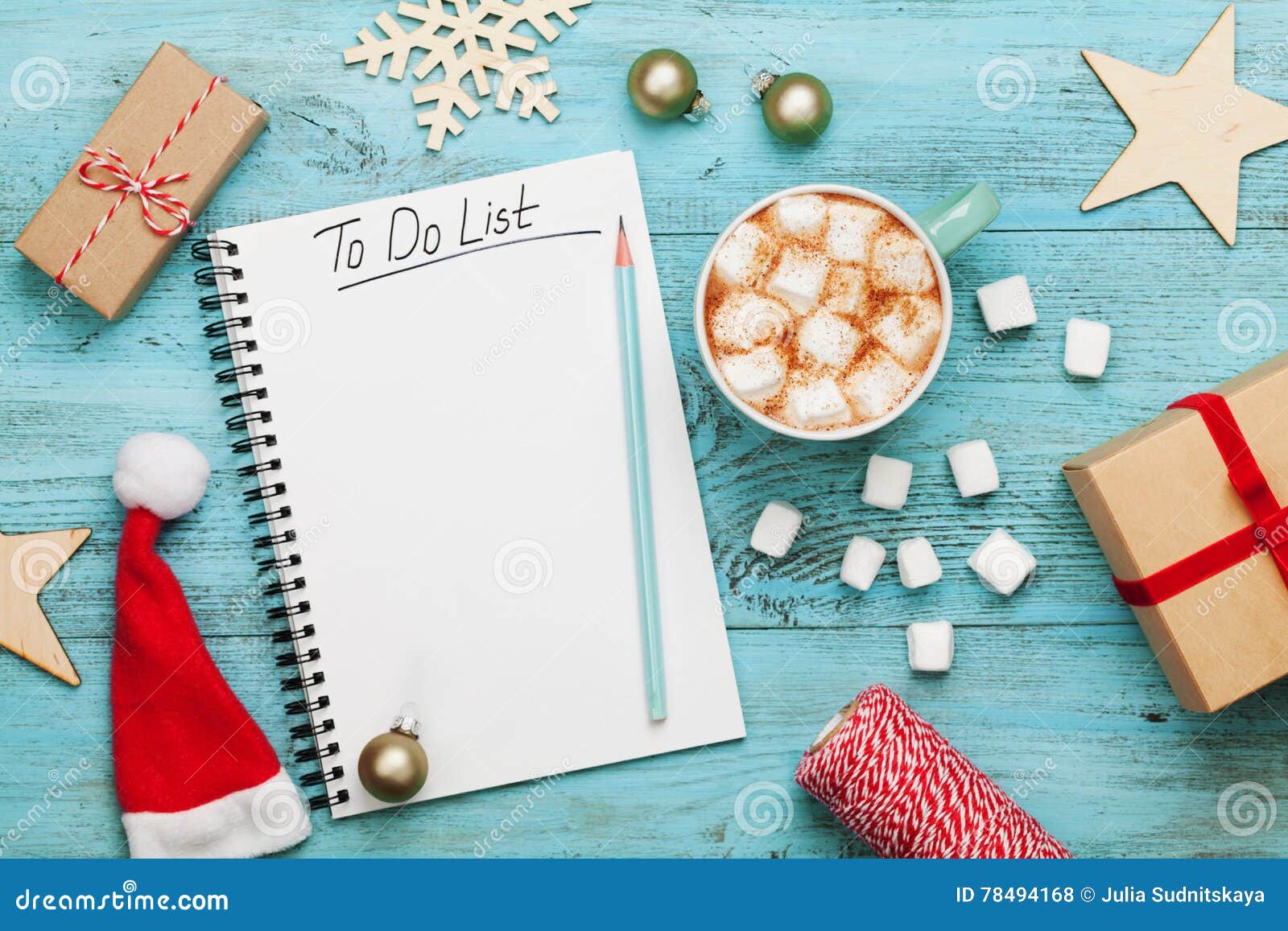 cup of hot cocoa or chocolate with marshmallow, holiday decorations and notebook with to do list, christmas planning. flat lay.