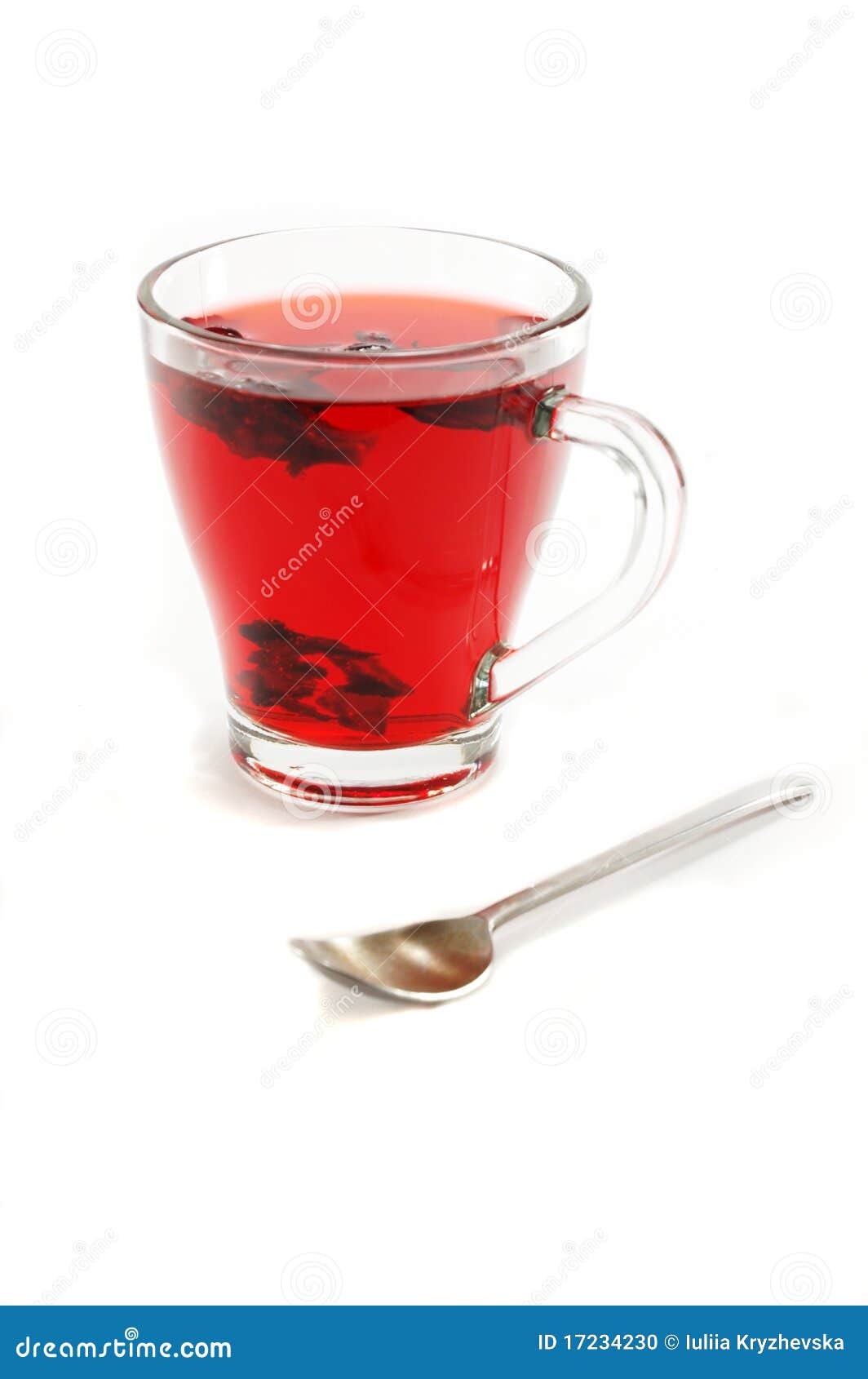 cup with hot red carcade floral tea and teaspoon