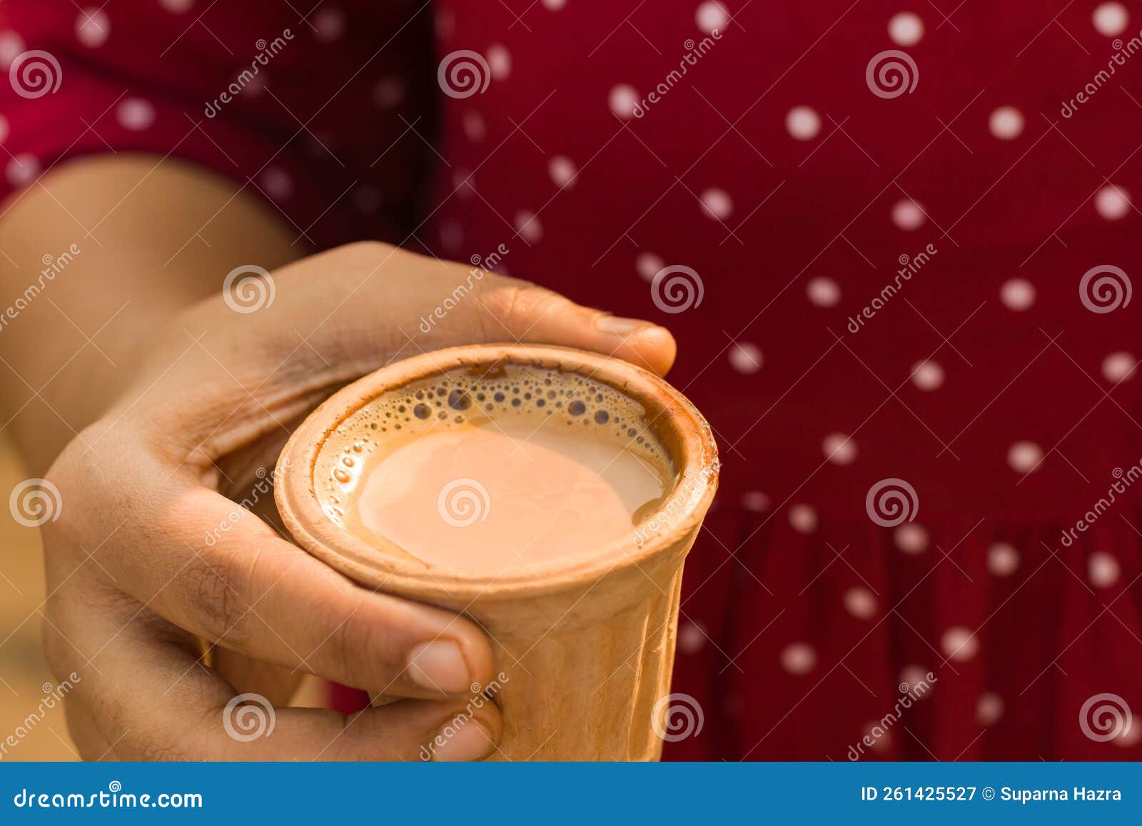 A Cup of Hot Tea Held in Hand. Popular Beverage Served in Earthen Clay