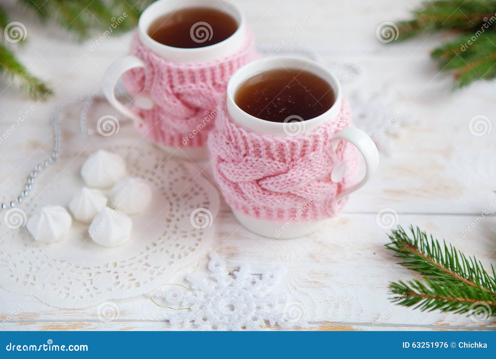 Cup of Hot Tea in Knitted Cup Holder with Sweets and Christmas