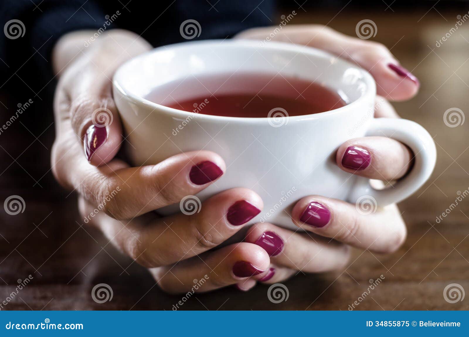 A cup of tea in hand stock image. Image of female, women 34855875