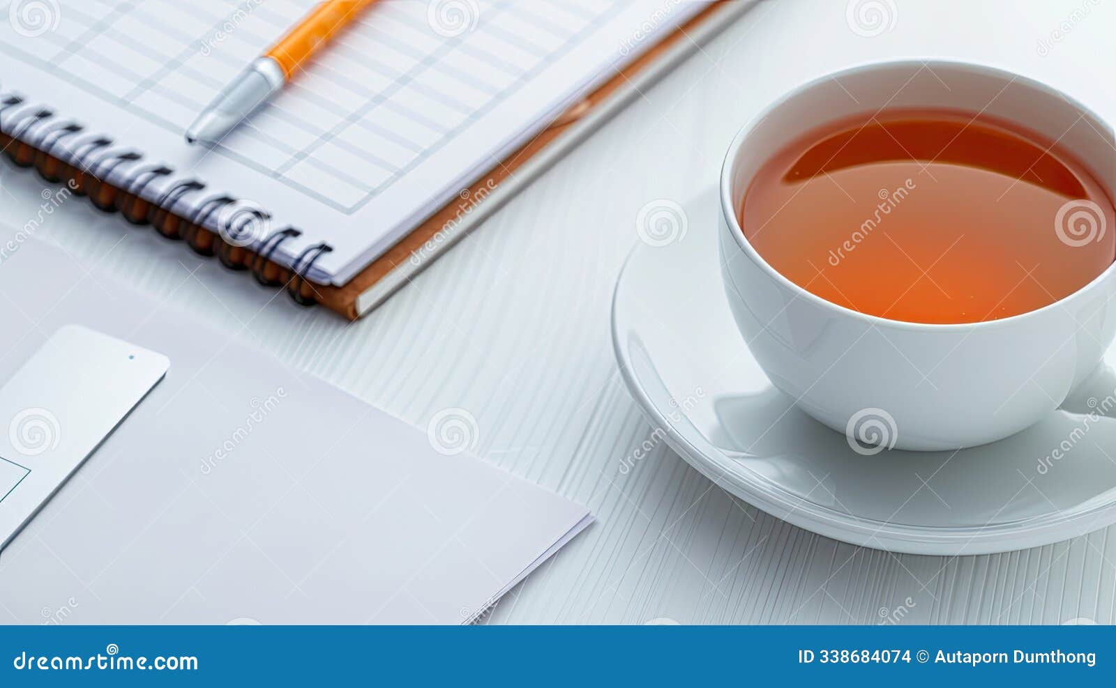 cup of tea with notebook, pen and smartphone on white workspace. ideal for work, productivity, and relaxation-themed visuals