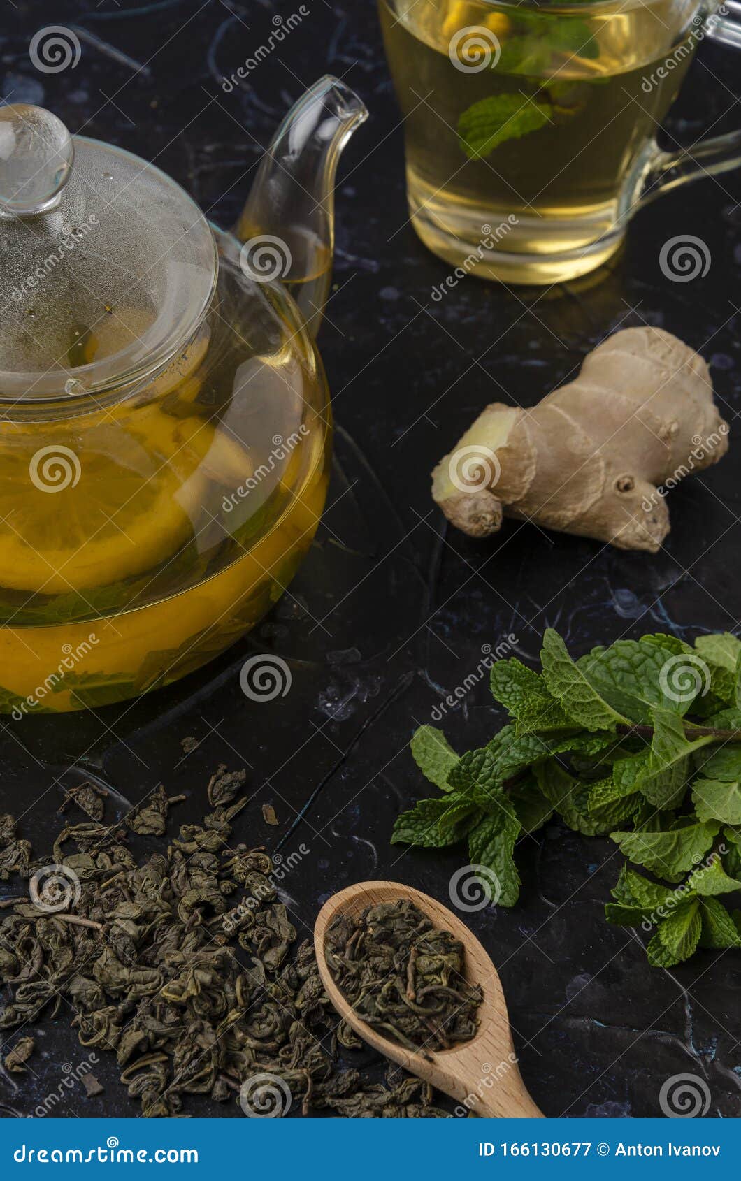 Cup and Teapot of Herbal Tea with Fresh Mint on Wooden Boards Stock