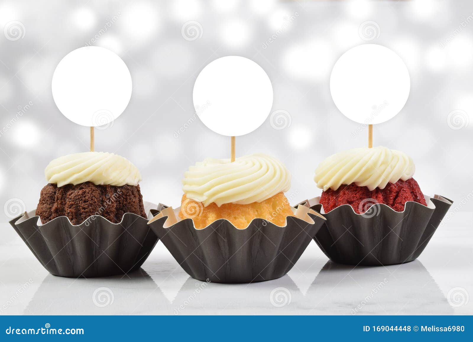 Download Cupcake Toppers Mockup With Three Gourmet Cupcakes And A Bokeh Patterned Background Stock Photo ...