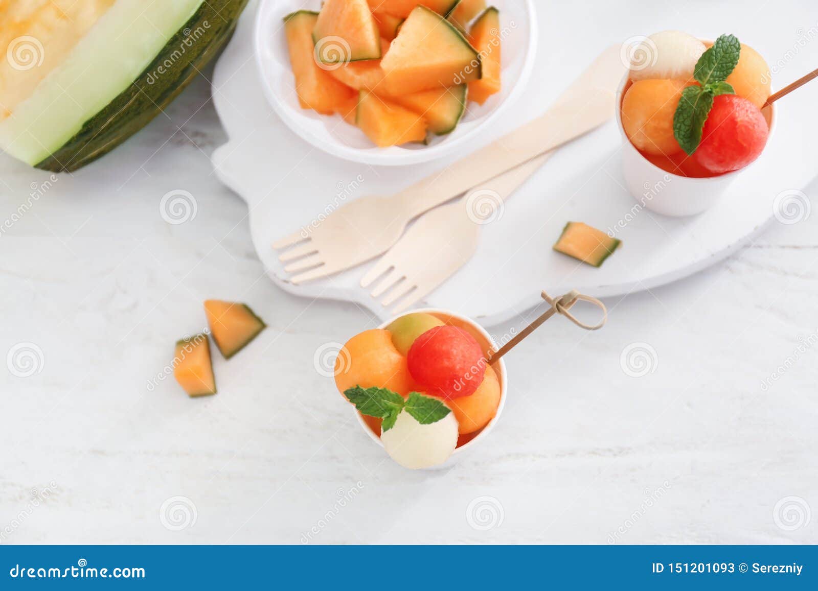 Cups with Fresh Melon and Watermelon Balls on Light Table Stock Image