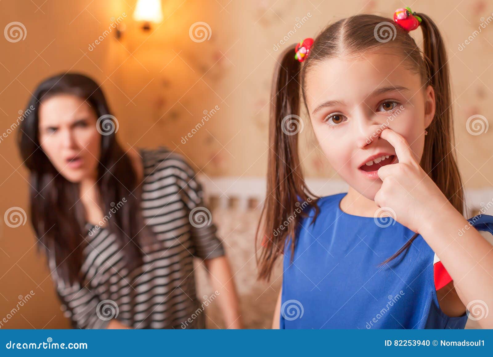 curious girl picking a nose