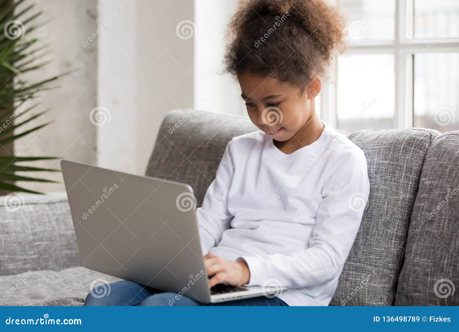 Curious Preschool African Mixed Race Girl Using Laptop at Home