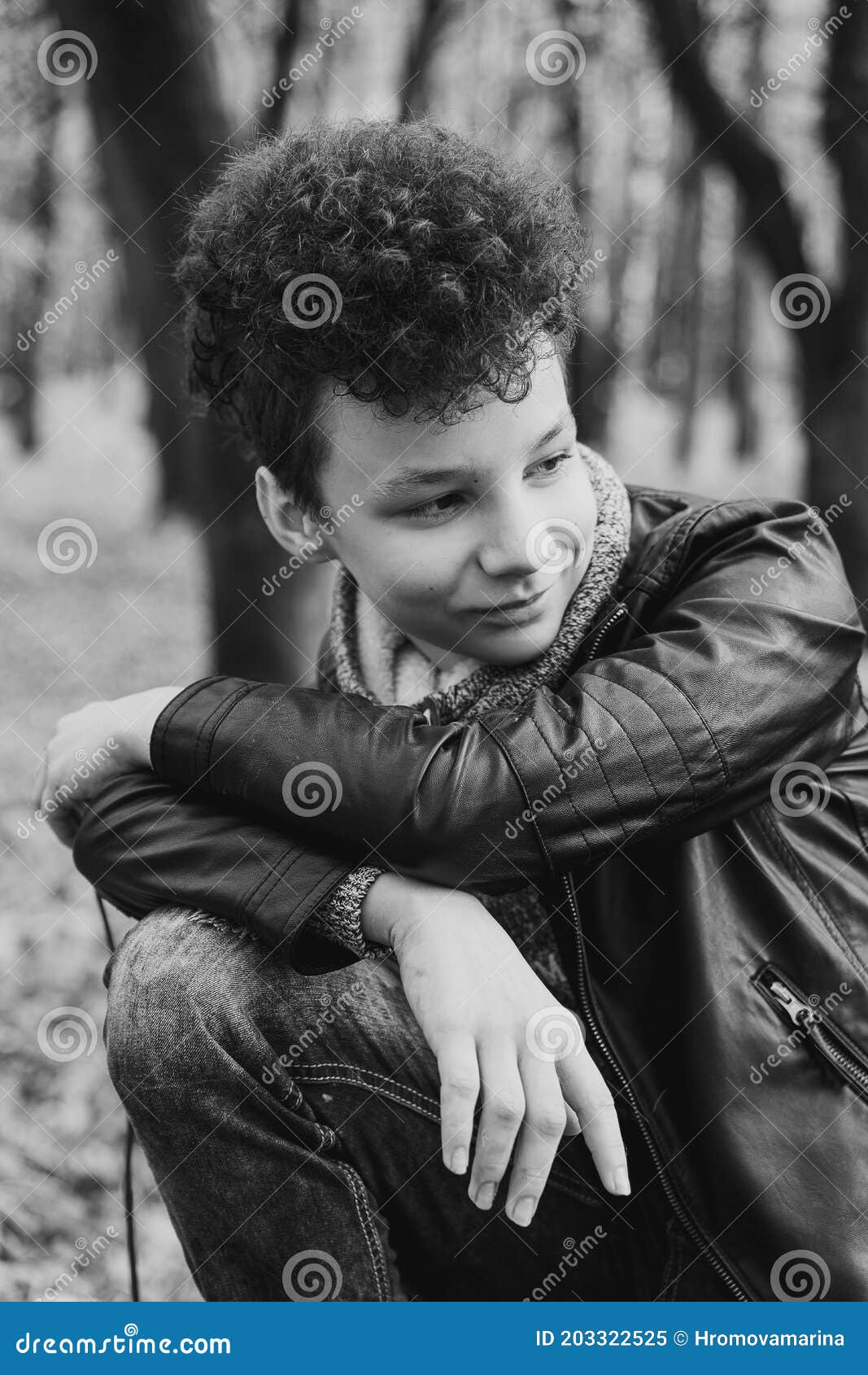 Curly Brown-haired Boy with a Mohawk Hairstyle in a Leather Jacket ...