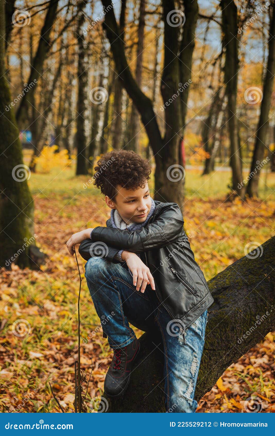 Curly Brown-haired Boy with a Mohawk Hairstyle in a Leather Jacket on ...