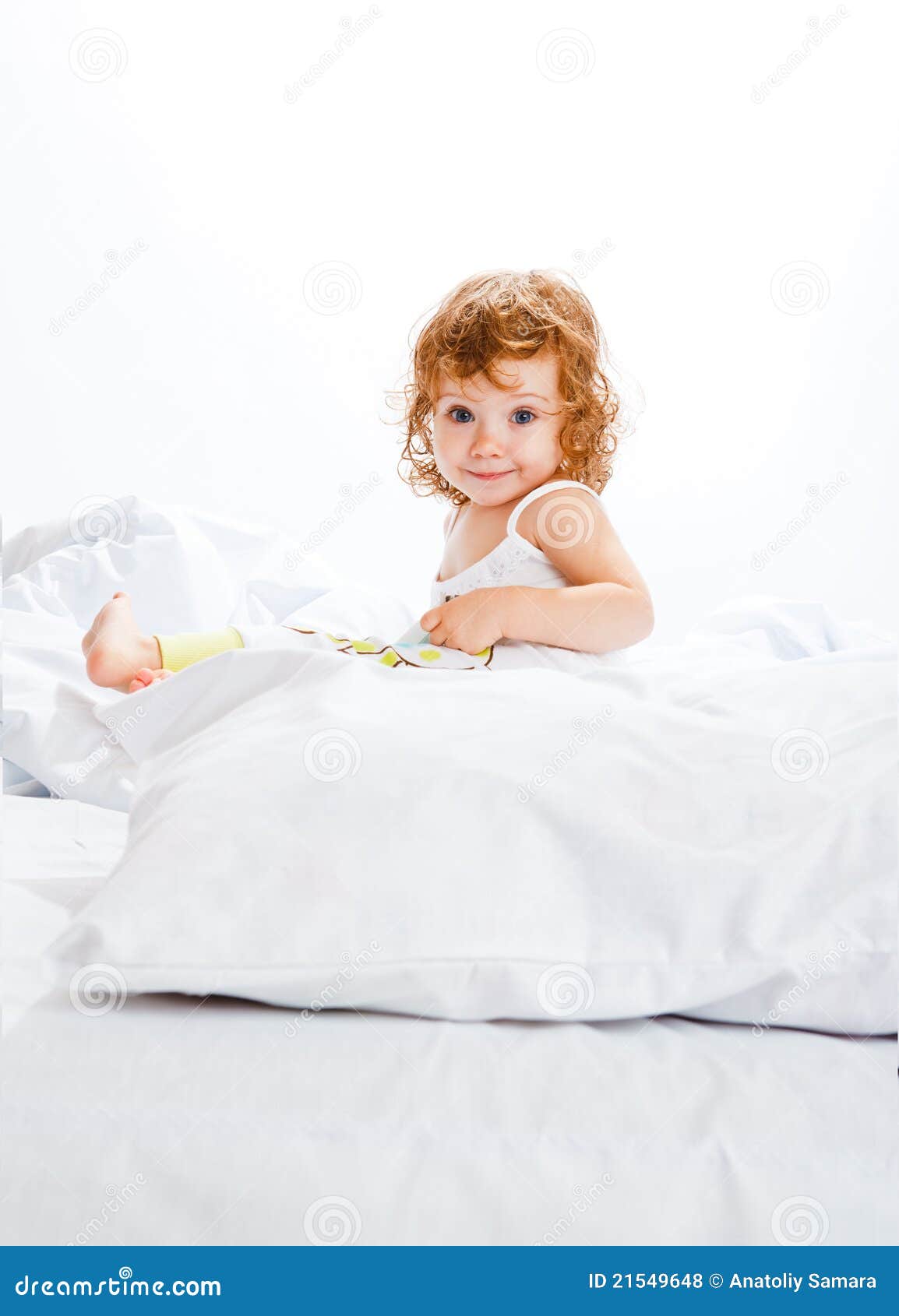 Curly toddler girl in bed stock photo. Image of childhood 21549648