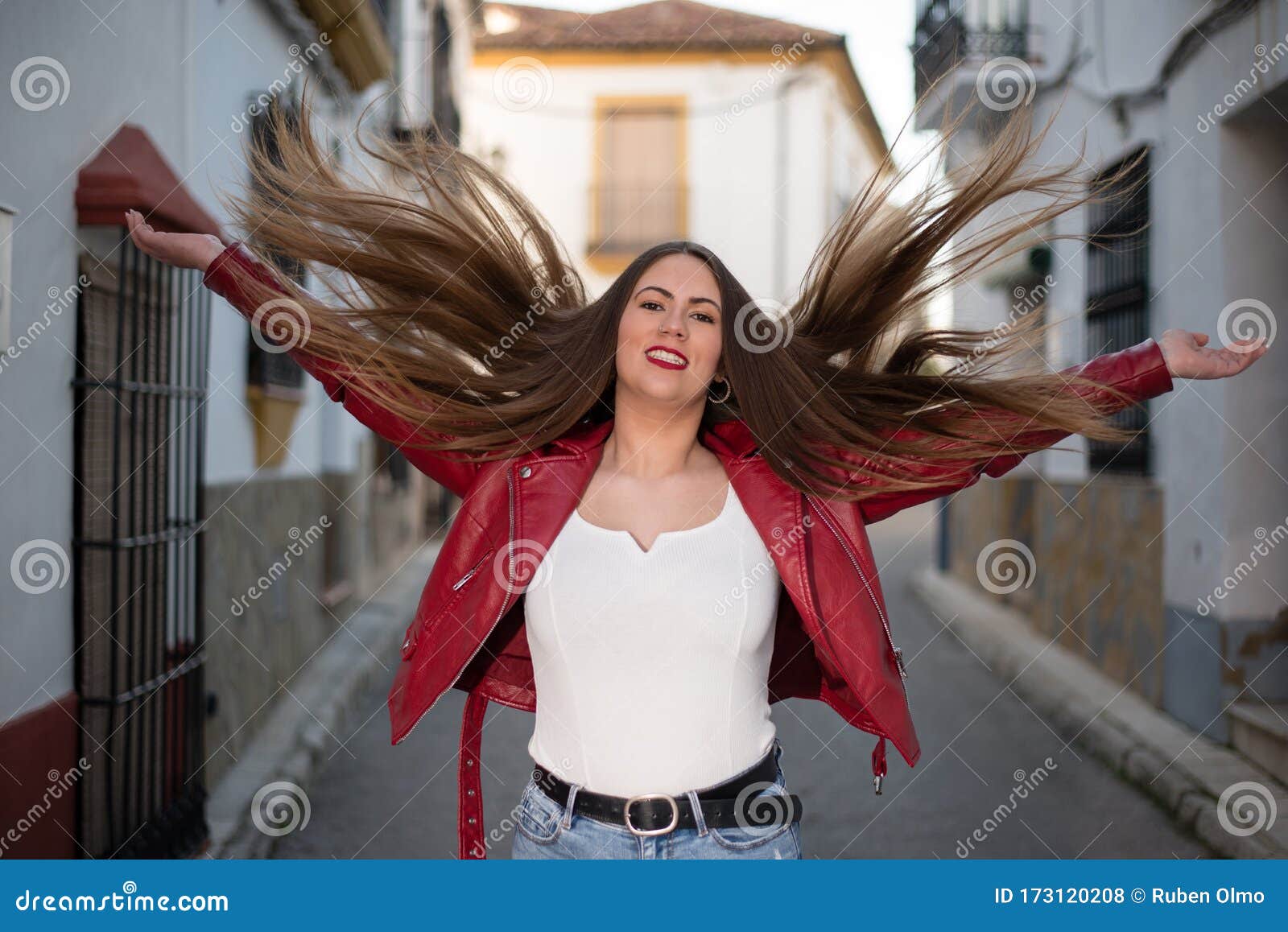 Curvy Pretty Girl in the Street with Her Long Brown Hair Raised in the Air  and Arms Open of Happiness Stock Photo - Image of hilarious, grin: 173120208