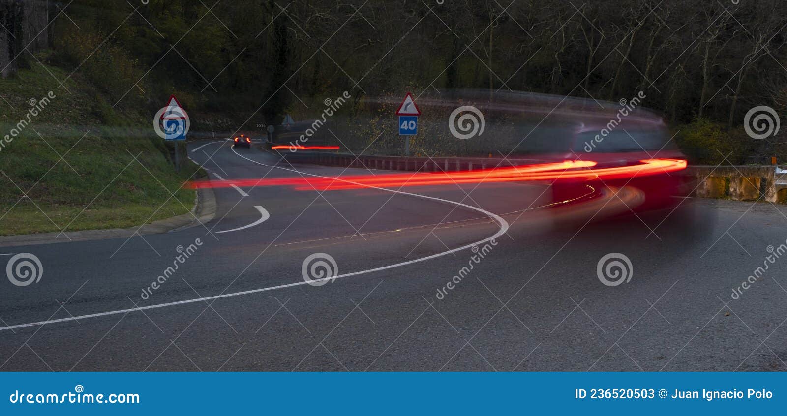 Curvy road and car lights stock image. Image of fast 236520503