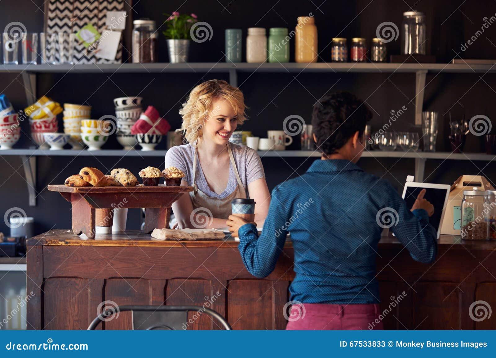 Customer in Coffee Shop Ordering Using Digital Tablet Stock Image