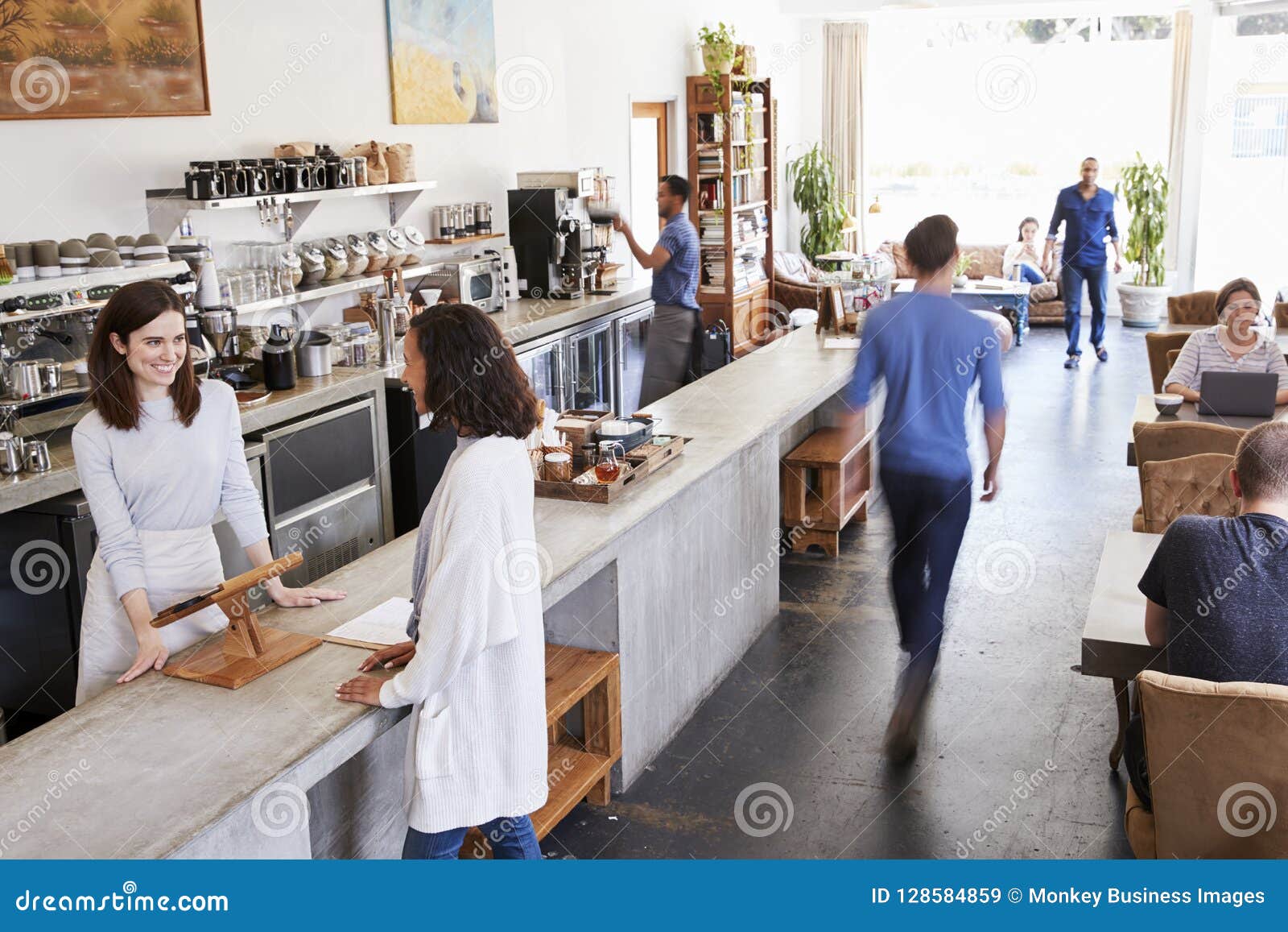 Customer at a Counter of a Busy Coffee Shop, Elevated View Stock Image