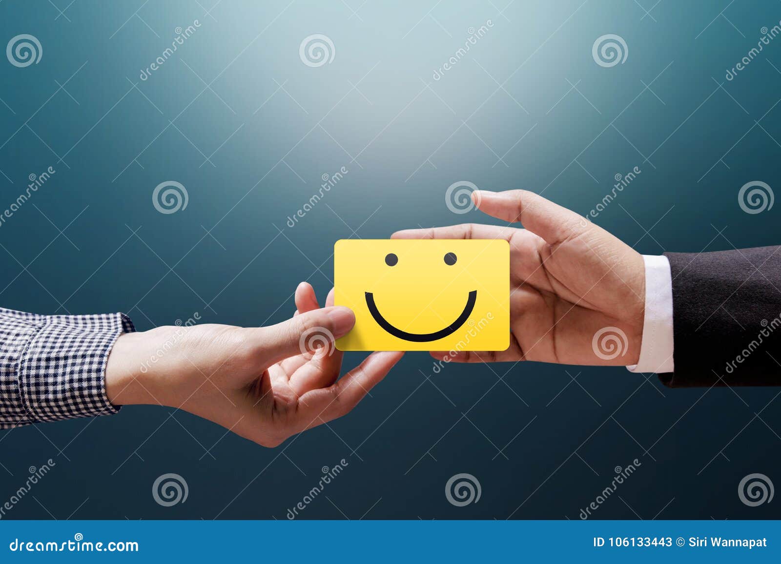 customer experience concept, happy client woman giving a feedback with happy smiley face card into a hand of businessman