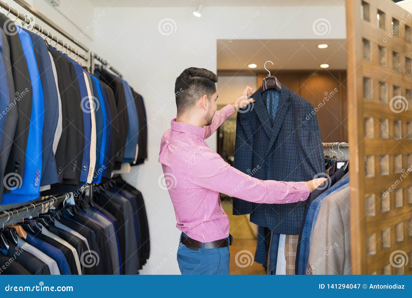 Customer Looking at Suit in Clothing Store Stock Image - Image of ...