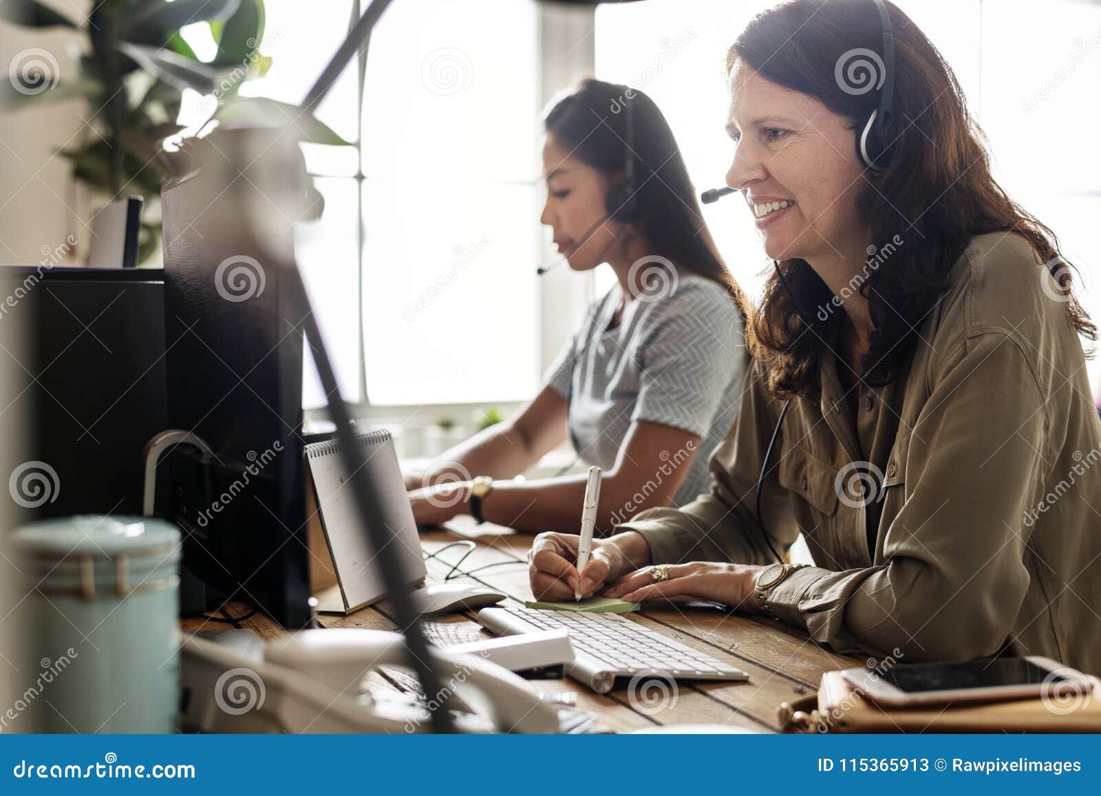 customer service workers sitting in front of computers working