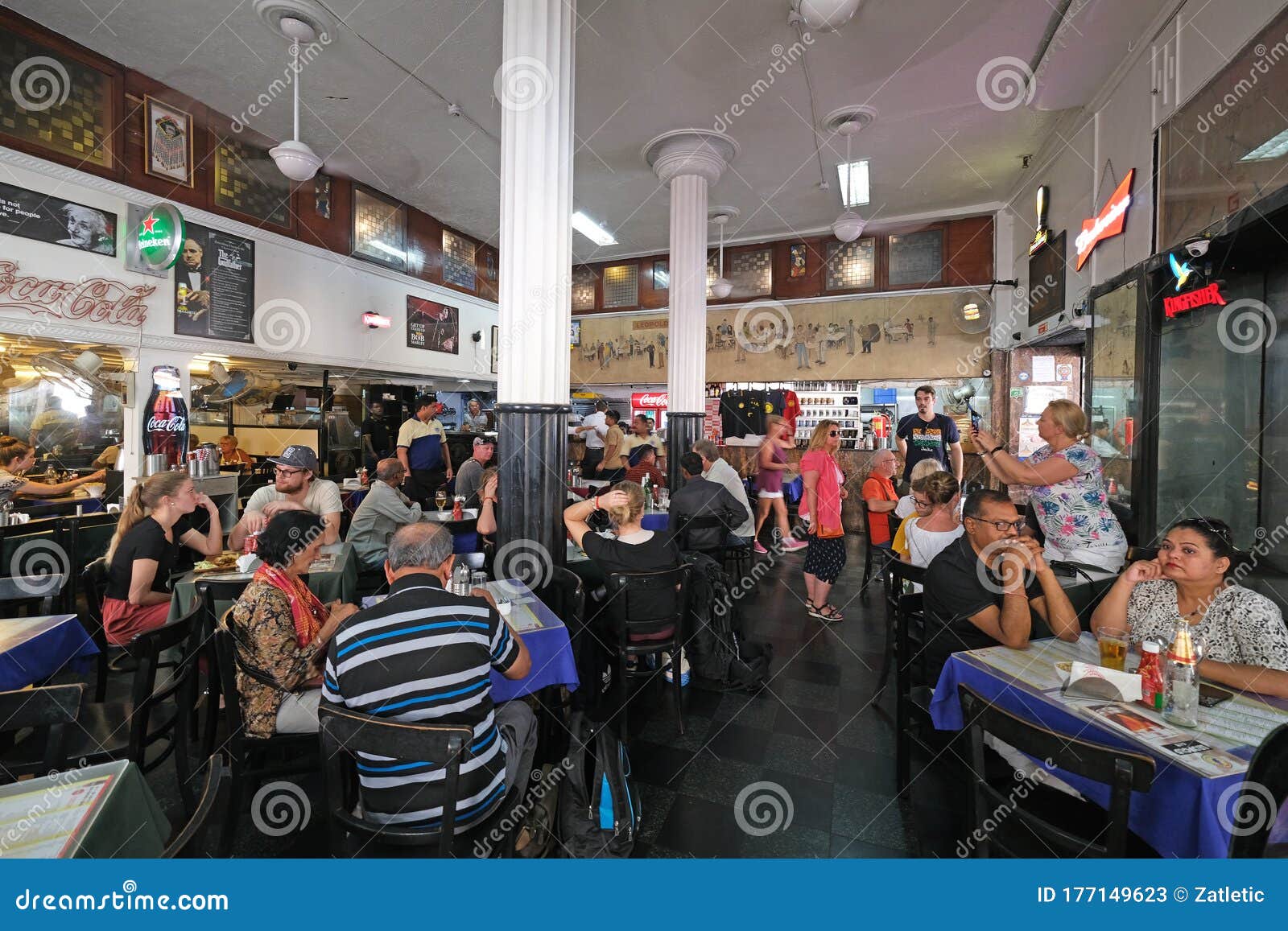 People eating and drinking inside Leopold cafe, Mumbai, India Stock Photo -  Alamy