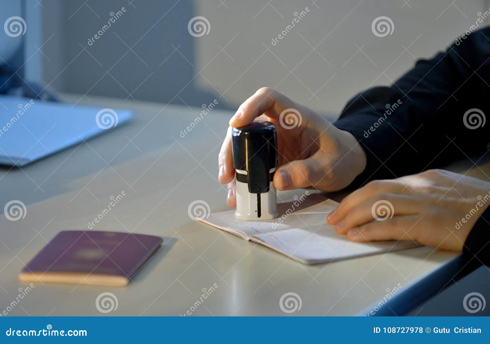 customs officer stamping a passport