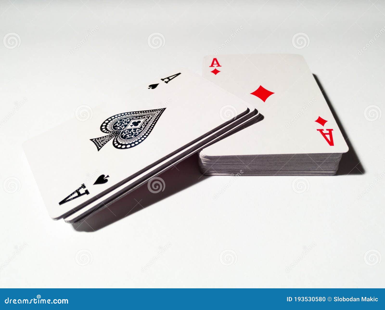 Cut Deck of Playing Cards with Spades and Diamonds, Isolated on a White