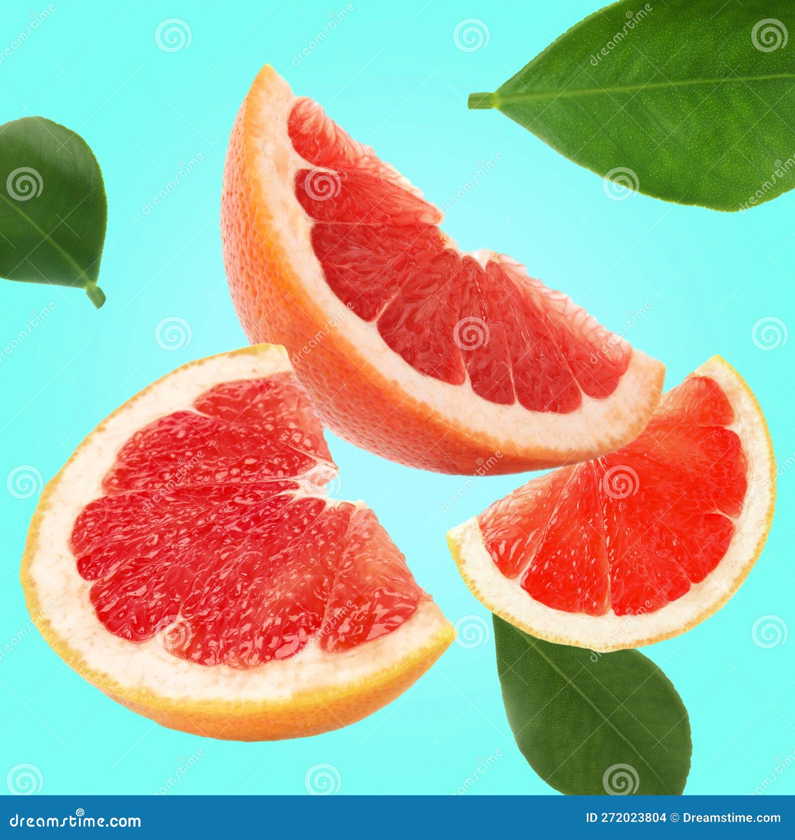Cut Fresh Grapefruit and Green Leaves Flying on Cyan Background Stock