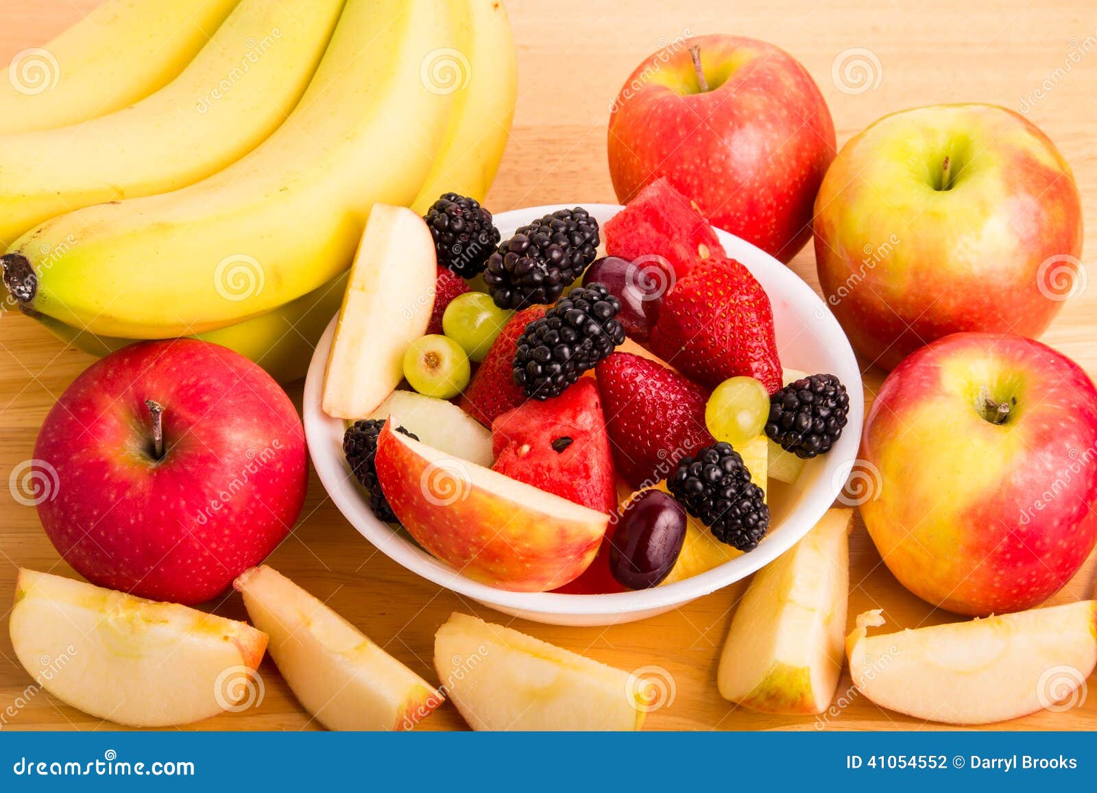 Cut Fruit in Bowl with Bananas and Whole and Cut Apples Stock Photo