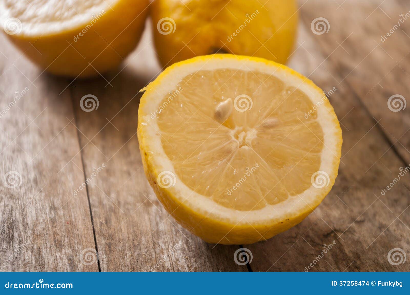 Cut lemon close up on wooden background