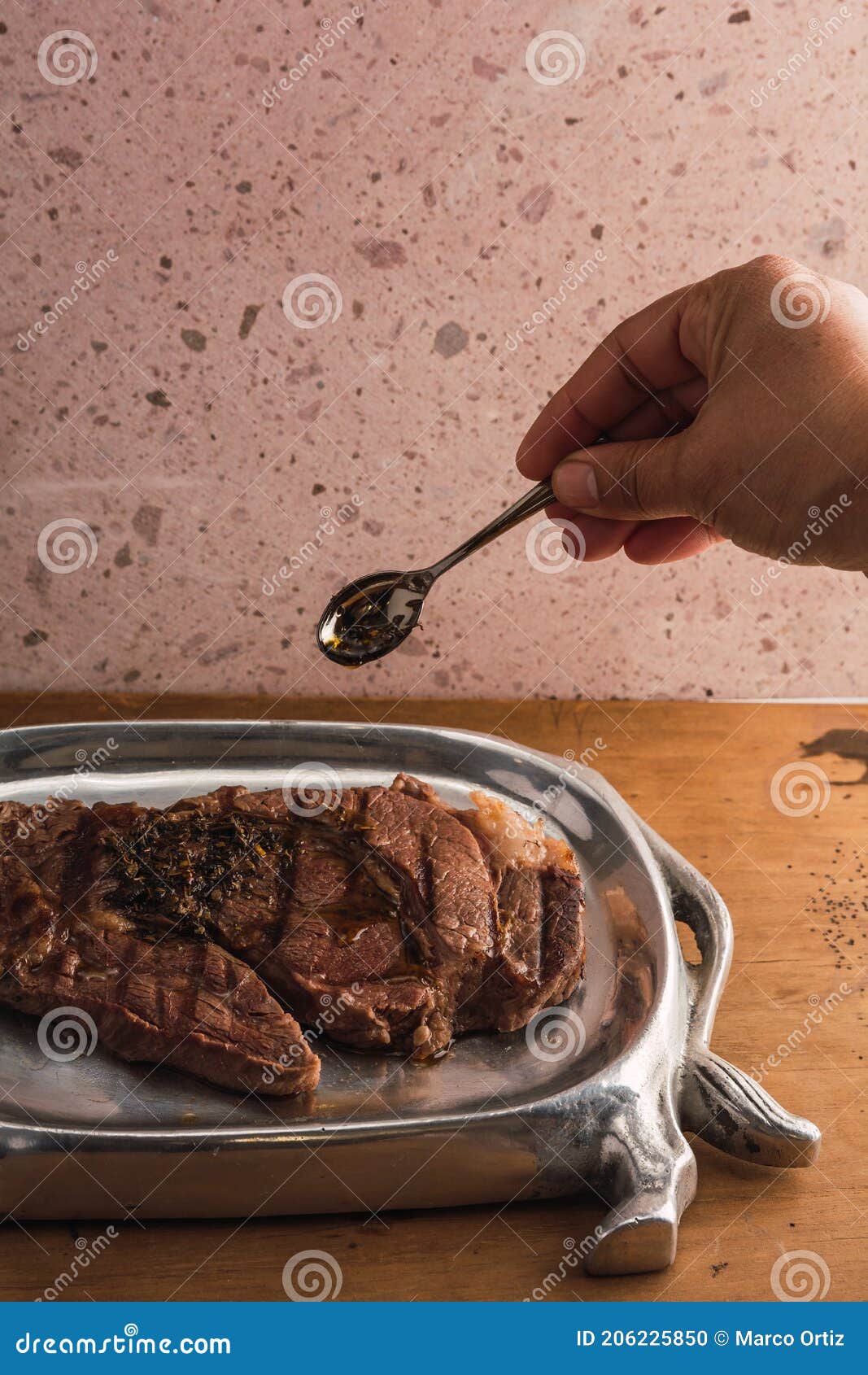 cut of meat `aguja norteÃÂ±a sonora`, served on a silver plate in the  of a cow 14