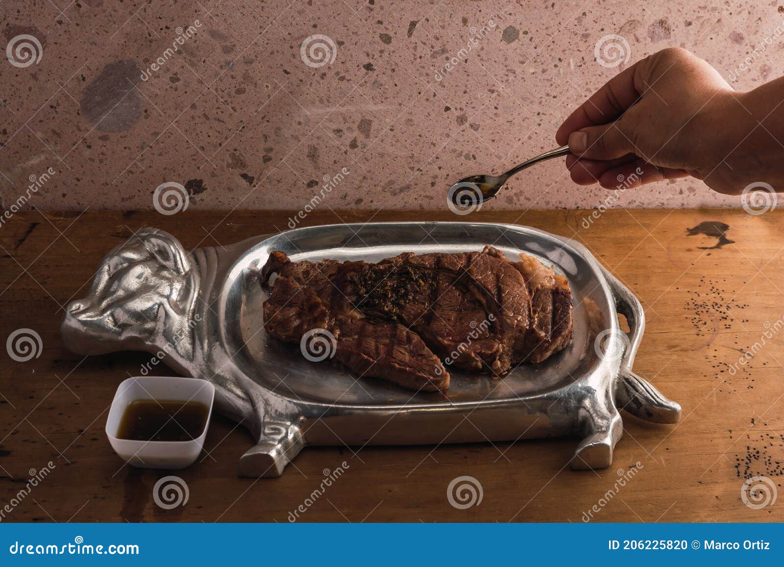 cut of meat `aguja norteÃÂ±a sonora`, served on a silver plate in the  of a cow 15