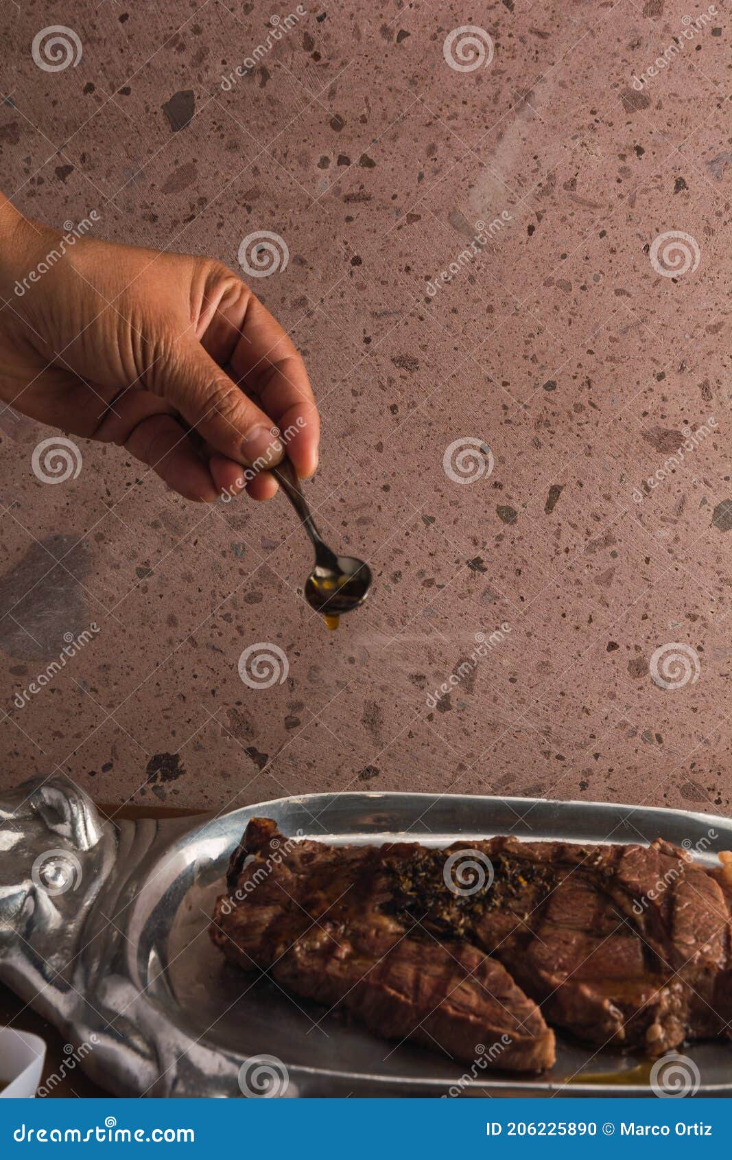 cut of meat `aguja norteÃÂ±a sonora`, served on a silver plate in the  of a cow 13