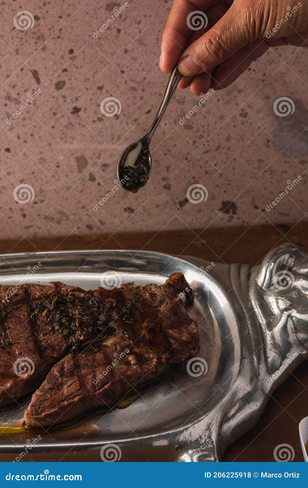 cut of meat `aguja norteÃÂ±a sonora`, served on a silver plate in the  of a cow 12