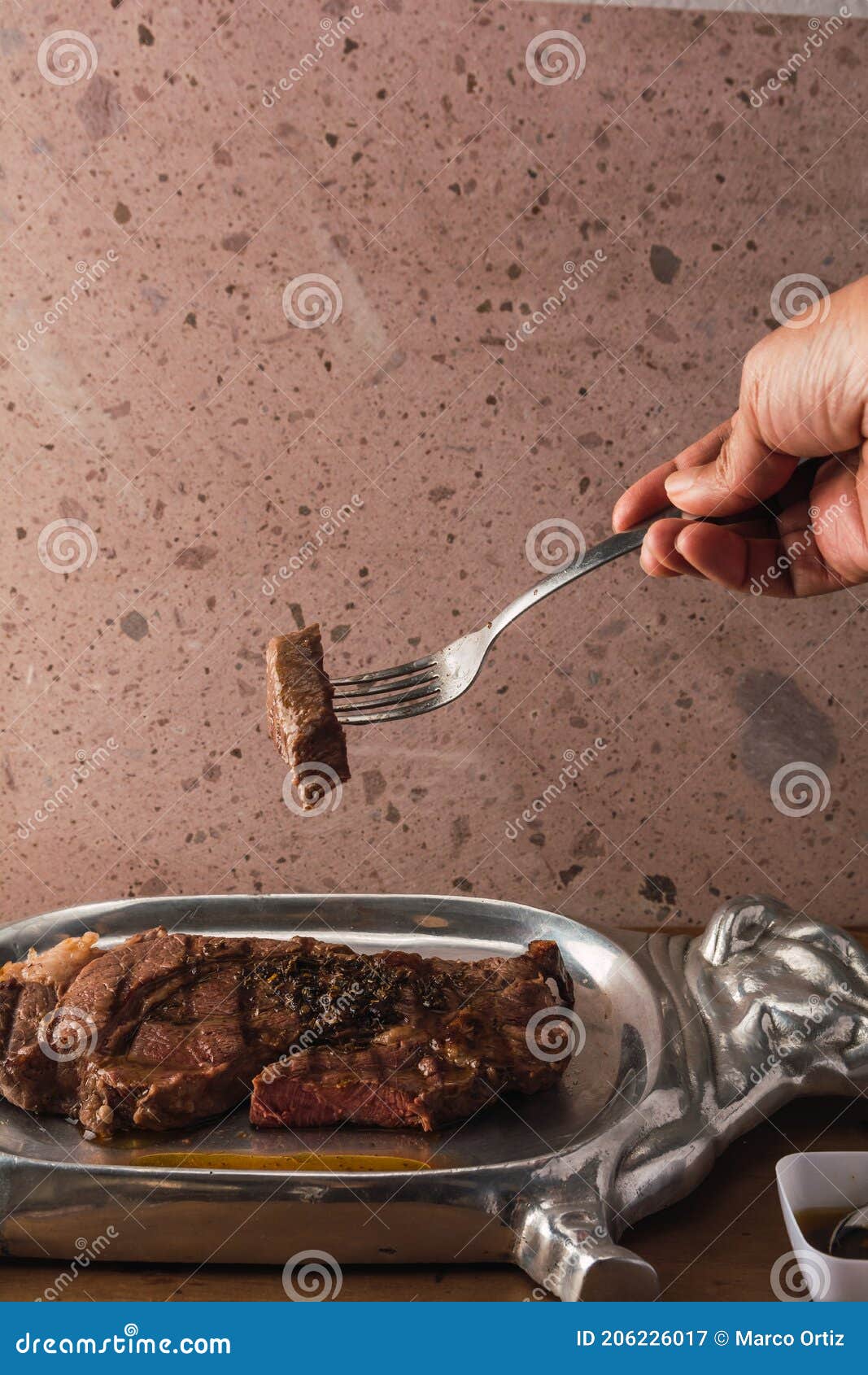 cut of meat `aguja norteÃÂ±a sonora`, served on a silver plate in the  of a cow 9