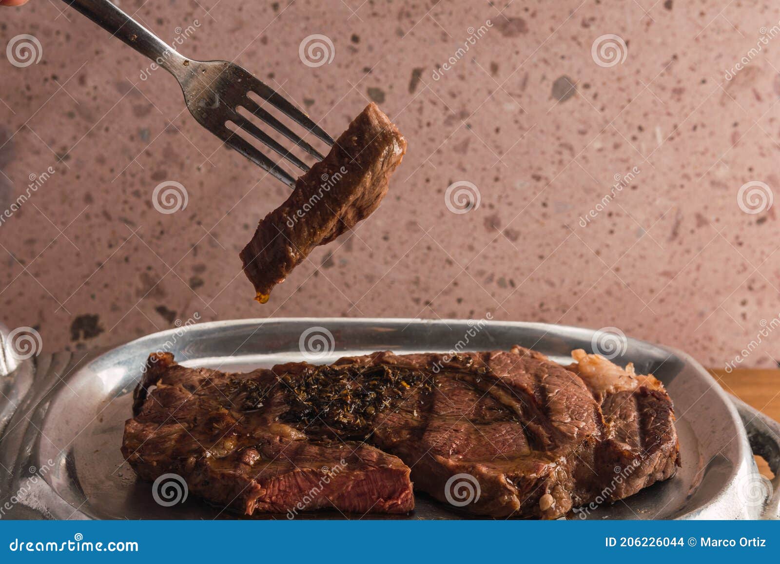 cut of meat `aguja norteÃÂ±a sonora`, served on a silver plate in the  of a cow 8