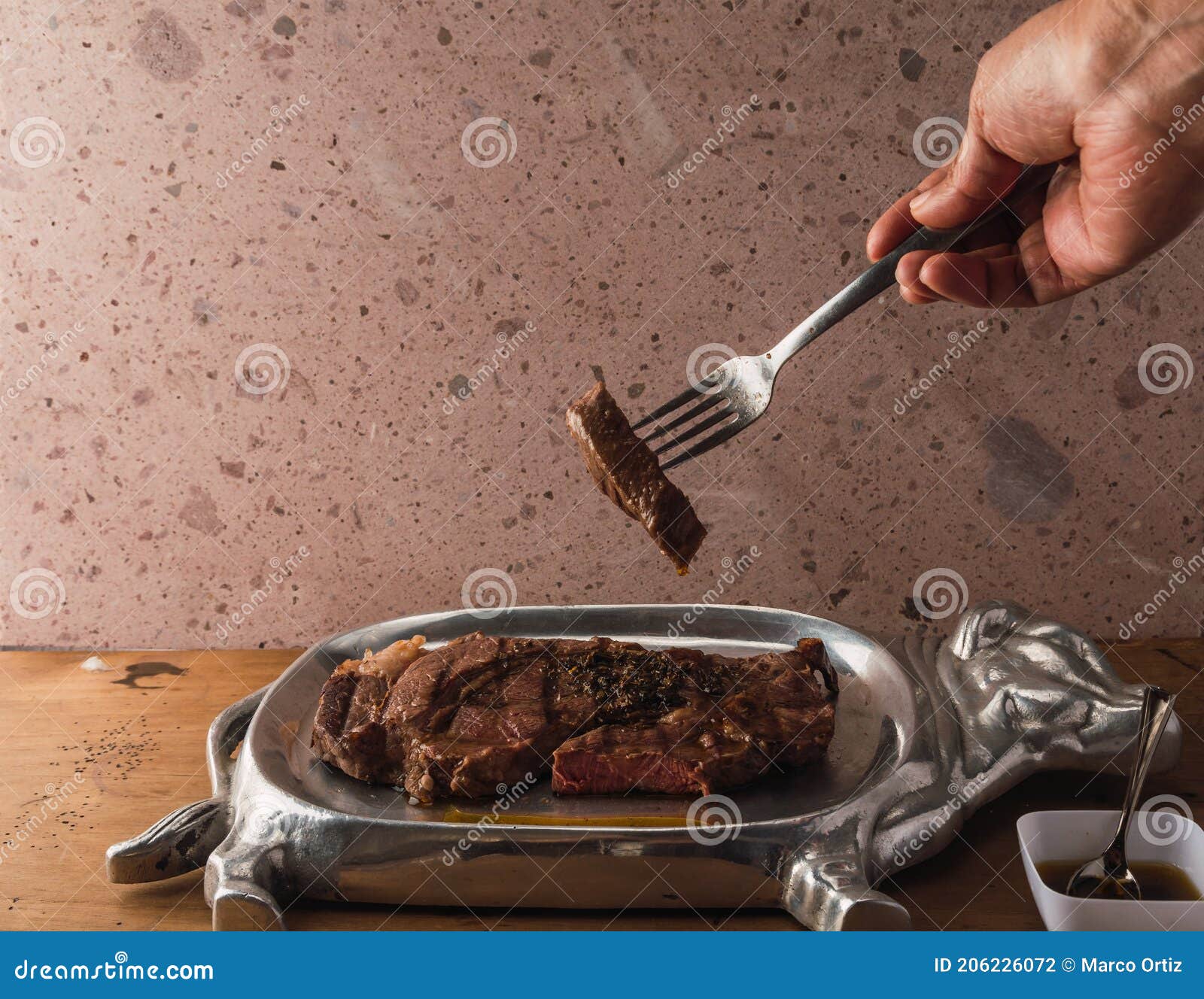 cut of meat `aguja norteÃÂ±a sonora`, served on a silver plate in the  of a cow 6