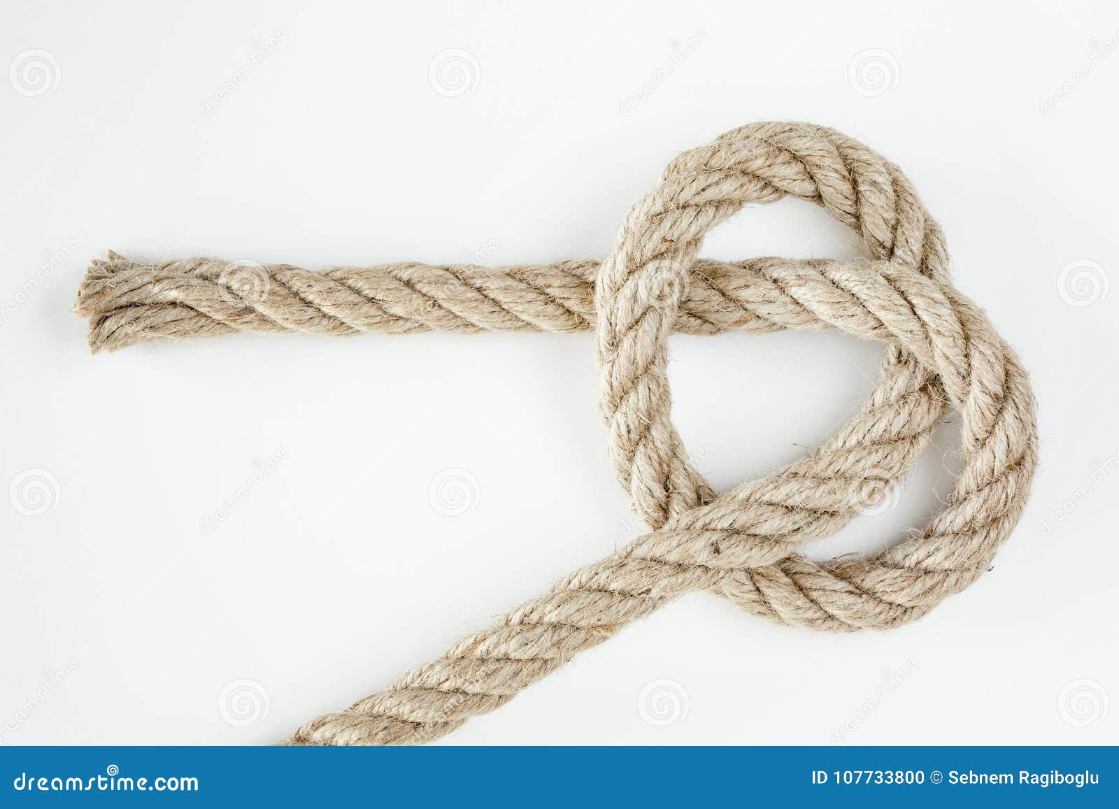 A Thin Rope Rolled With A White Background Stock Photo - Download