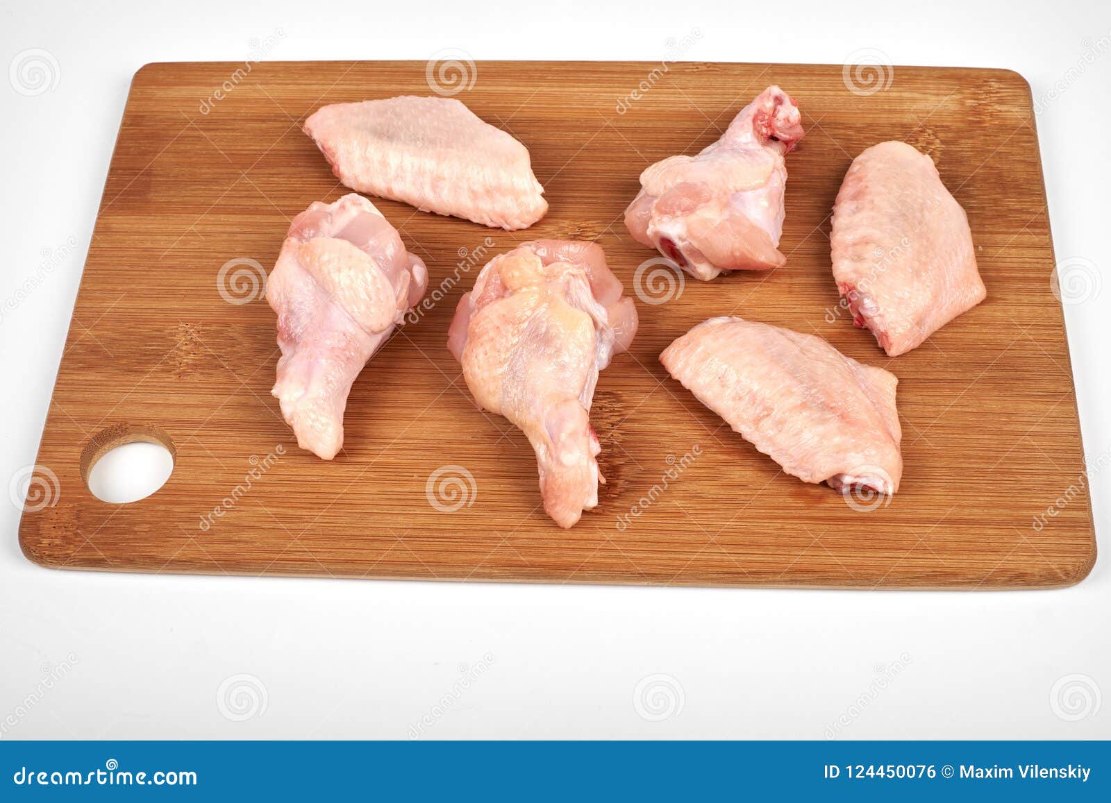 Cut Raw Chicken Wings on a Cutting Board Isolated on White Background