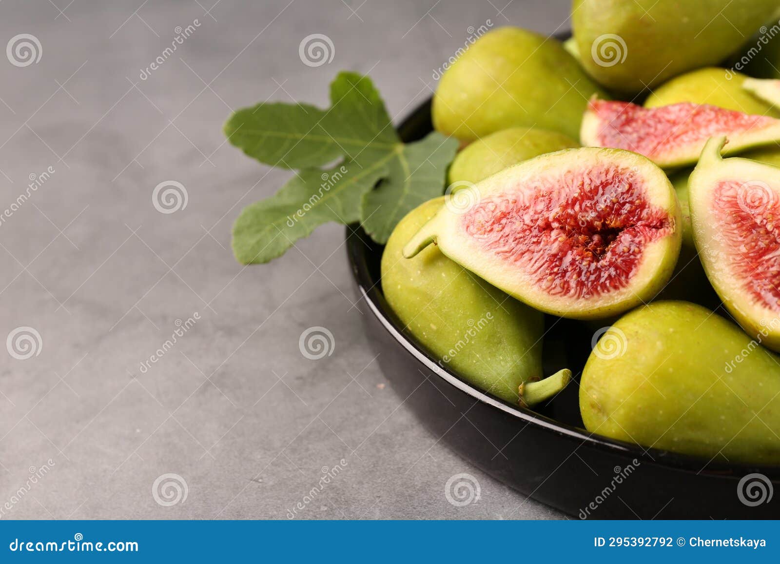 Cut and Whole Green Figs on Light Gray Table, Closeup. Space for Text