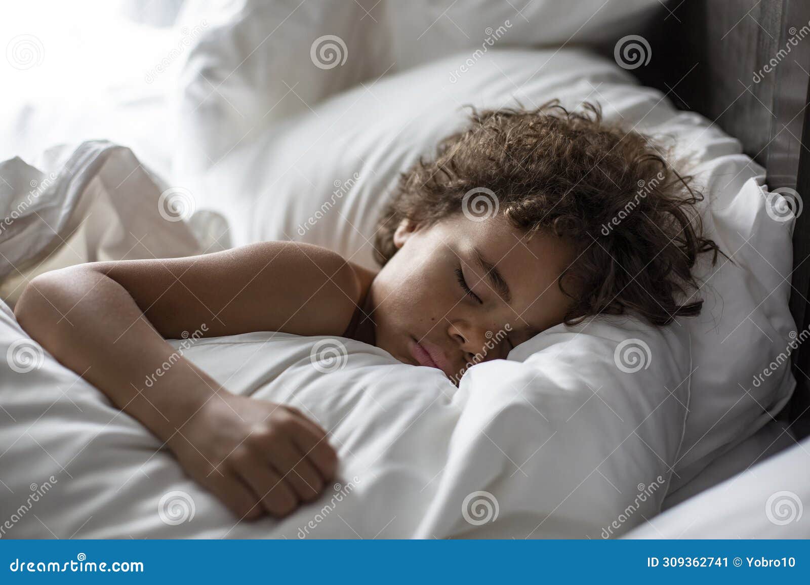 cute african american little boy sleeping soundly in his nice warm bed