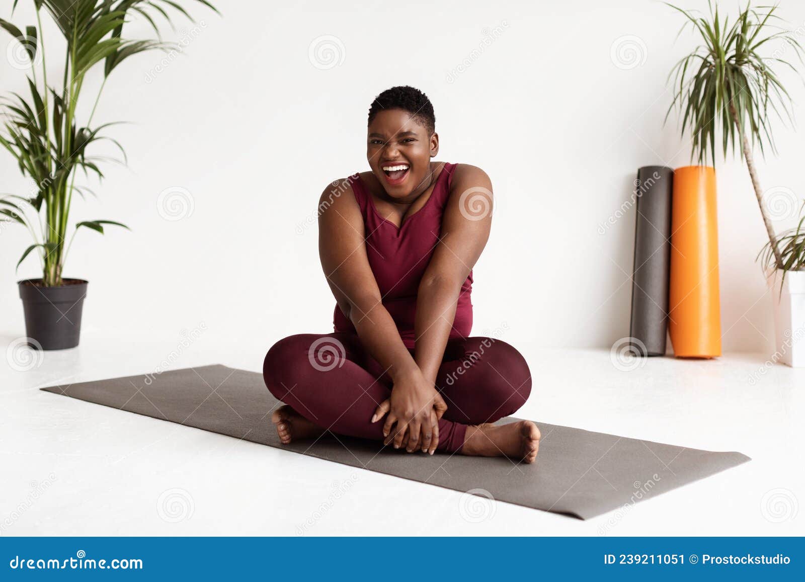 Cute African American Woman Plus Size Sitting on Fitness Mat Stock