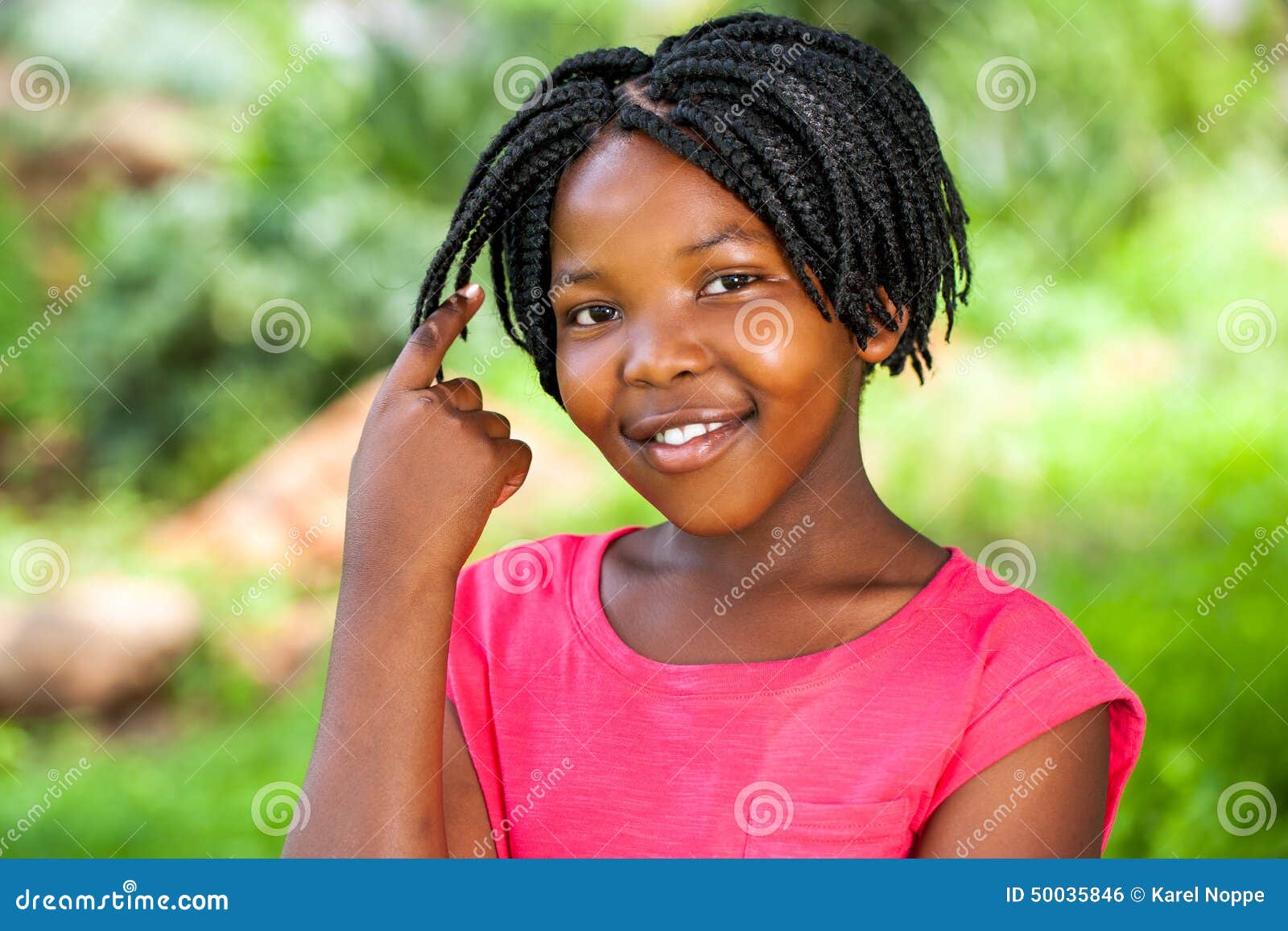 cute african girl showing braided hair.